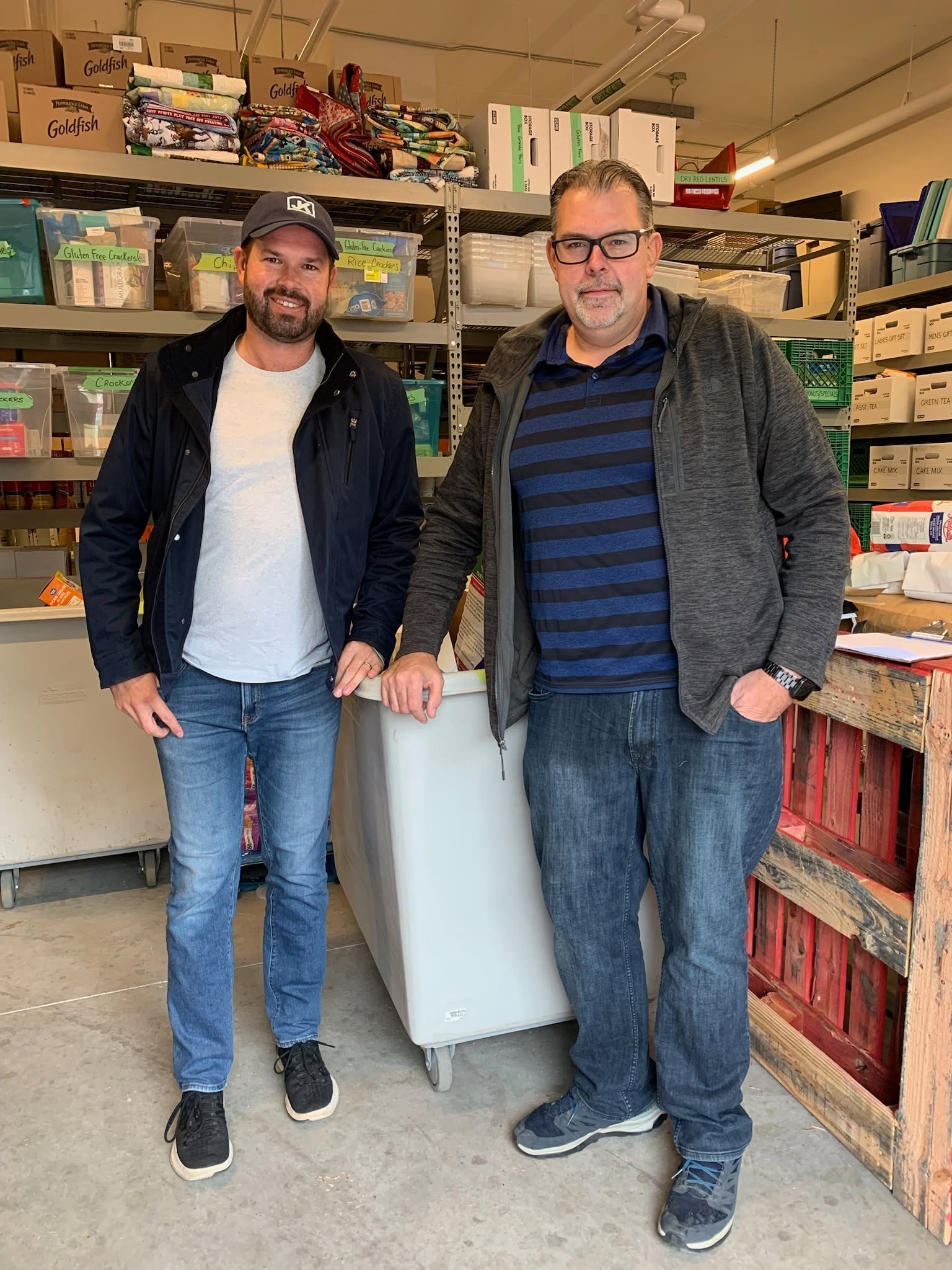 John Kelly and SHORA representative at the Compass Food Bank with donated goods