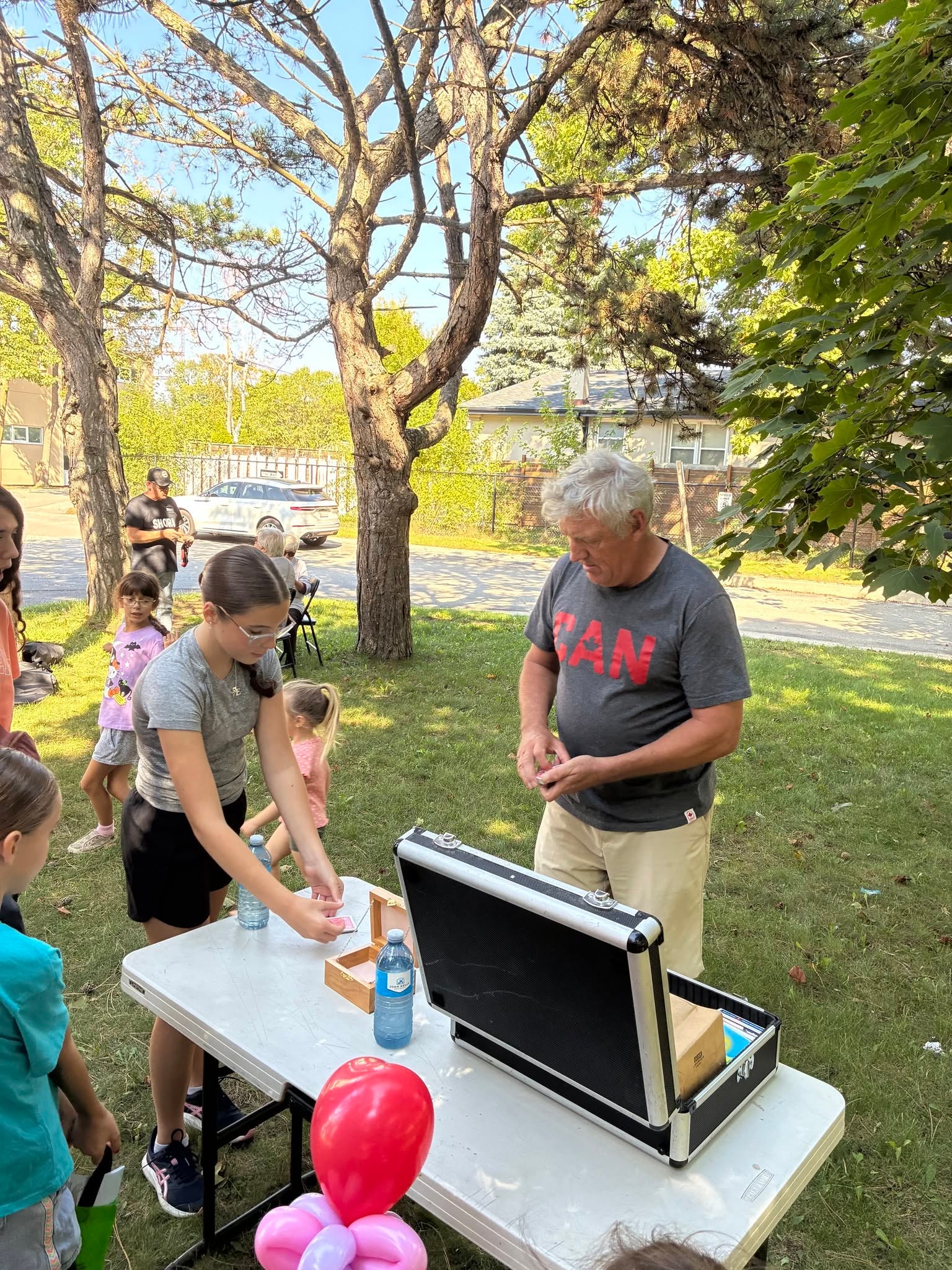 Volunteer running a magic show activity for children at the Pumpkin Giveaway
